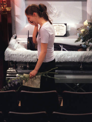 A mourner moves slowly past the casket of Isaiah Shoels at the Heritage Christian Center.