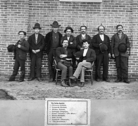 Filemeno Gallotti, Leonardo Deodato, Michale Ballatti, Guiseppe Campigne, Frank Valendre "The Miner", Henry Ferandez, John Arrati, Leonardo Allesandre, and "The Ranchman", a group of criminals, pose outdoors in Denver, Colorado.