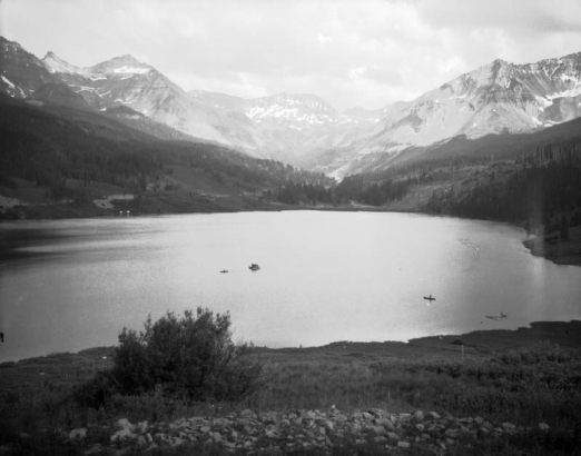 View of Trout Lake, in (probably) San Miguel County, Colorado; shows boats and surrounding mountain peaks.