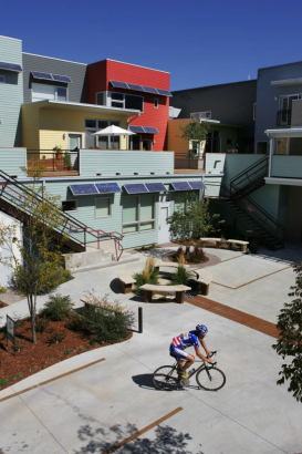 Rresident Paul Mack (Cq) returns home after a bike ride to his solar condo complex by architect Michael Tavel (cq), in the Prospect community in Longmont, Co. on Sept. 19, 2006.  Tavel won the architects' choice award.  Above the windows are solar pane...