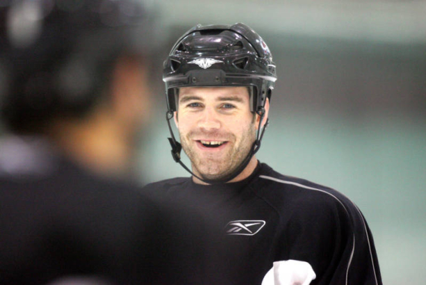 Colorado Avalanche defenseman Bob Boughner (#6) flashes a smile at a temmate before a voluntary light practice at the Family Sports Center Ice Arena in Centennial on Tuesday April 25, 2006. Many on the team have to be smiling after a pair of wins again...