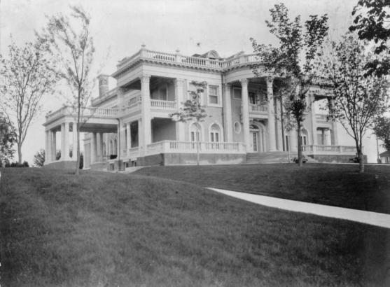 Exterior view of former Colorado Governor James B. Grant's residence (later called Grant-Humphreys Mansion), 770 Pennsylvania Street, Denver, Colorado. The neo-classical building has a semicircular portico supported by Corinthian columns.