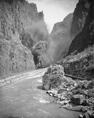 View of a Denver & Rio Grande Western Railroad passenger train at Hanging Bridge, Royal Gorge of the Arkansas River, Fremont County, Colorado.