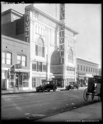 View of the (William Fox) Rivoli Theater at 1751 Curtis Street in  Denver, Colorado; sign advertises the film "Passion", starring "Pola Negri  & cast of 5,000." Landmarks include Original Frisco Restaurant, Cosmos Hotel, Chas. Bomash Loan Office, and Paris Restaurant.