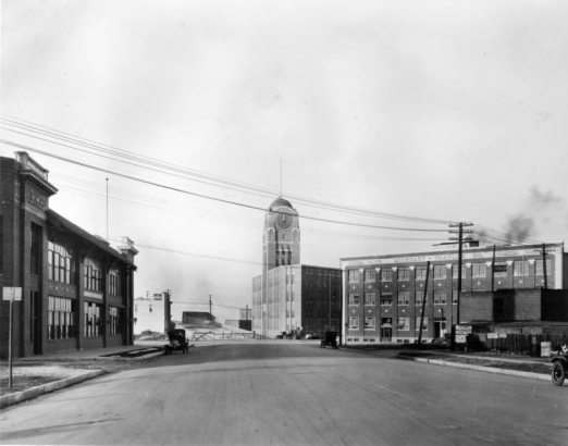 View of the entrance to the Broadway Viaduct in Denver, Colorado. The McPhee McGinnity Building is near the bridge. Signs on and near buildings read: "The Silver State Laundry Co.," "Minehart-Traylor Co.," and "Joel L. Shackelford Realty Company."