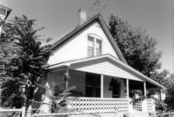 View of a house at 2655 Stout Street in the Five Points (Curtis Park) neighborhood of Denver, Colorado. The two-story house has a covered porch with a decorative wall.