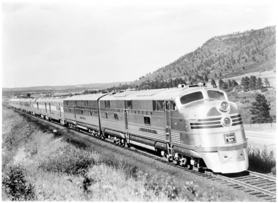 Colorado & Southern publicity shot on September 8, 1940 shows Texas Zephyr 9950 (also known as the Silver Racer) plus additional diesel unit engine, a Burlington Route high speed silver streamliner with eight baggage and passenger cars, near Larkspur, Douglas County, Colorado.