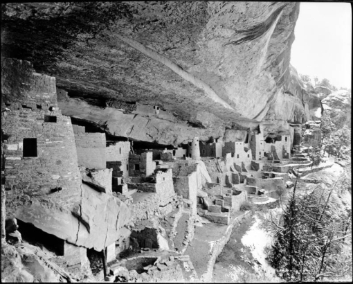 Cliff Palace, Mesa Verde National Park, Colorado. View from under  roof of cave of Native America (Anasazi) prehistoric cliff dwelling, a stone masonry structure with living quarters, storerooms, and kivas; shows snow on outside slope.