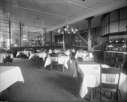 Interior view of the Daniels and Fisher store in Denver, Colorado; shows the dining room, tables, and wooden screens.