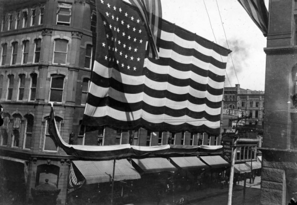 View of the Daniels and Fisher Stores Company, in Denver, Colorado, draped in a United States flag.