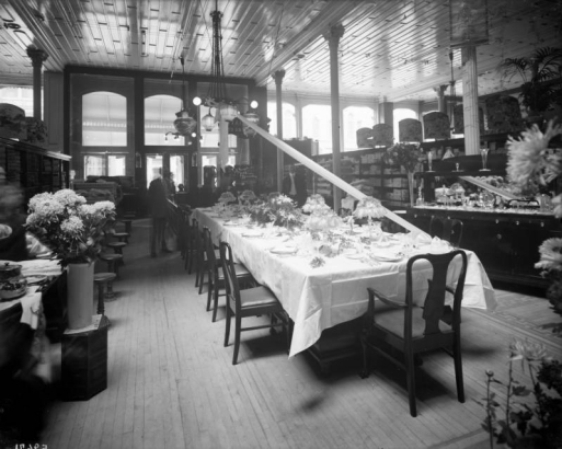 Interior view of the Daniels and Fisher store in Denver, Colorado; shows displays of dinnerware, flowers, and lamps.