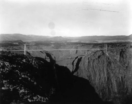 View across Royal Gorge, bisecting Fremont Peak, of the Suspension Bridge, Fremont County, Colorado, over 1000 feet above the Arkansas River. Built by the Royal Gorge Bridge and Amusement Company in six months, dedicated on December 6, 1929.