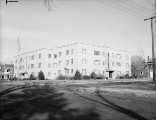 Brick, three story, apartment building at the corner of 21st and Franklin Streets in the Five Points neighborhood of Denver, Colorado.