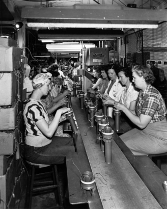 Women work on an assembly line at the Heckethorn Manufacturing Company in Littleton (Arapahoe County), Colorado. They work with metal cylinders with wires.