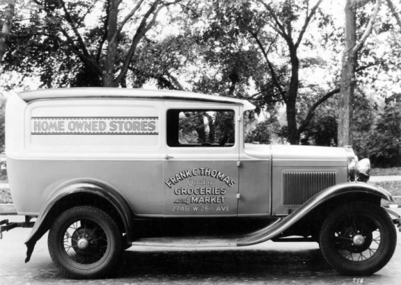 View of a delivery truck in Denver, Colorado; lettering reads: "Home Owned Stores," "Frank C. Thomas Quality Groceries and Market 2746 W. 26th Ave."