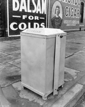 View of a trash can in Denver, Colorado; letters read: "Rubbish." Advertisements read: "Balsam for Colds," and "Cordove Cigar Co."