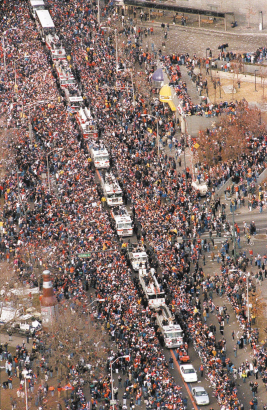 A caravan of fire trucks carry the Denver Broncos south down Broadway to Civic Center Park.  A crowd of 375,000 waited to greet the Super Champions for a parade and rally after they returned from winning Super Bowl XXXIII in Miami.