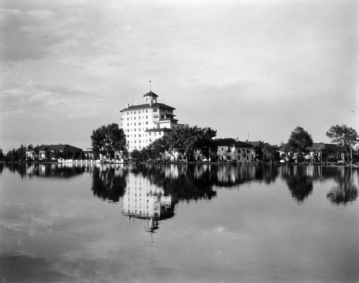 View of the Broadmoor Hotel and Lake in Colorado Springs, El Paso County, Colorado; the Italianate resort is reflected in the water.