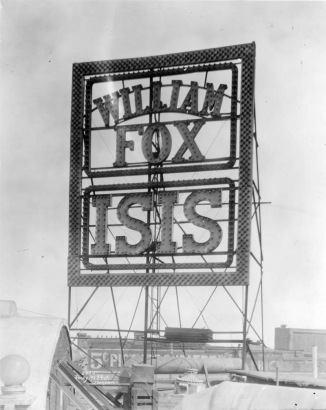 View of an electric sign on the roof of the Isis Theater at 1722 Curtis Street in downtown Denver, Colorado. The sign reads: "William Fox Isis."