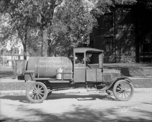 View of an O'Malley-Kelley Oil and Auto Supply Company delivery truck in Denver, Colorado. Lettering on the side of the cab reads: "Zuni St & Lake Place."