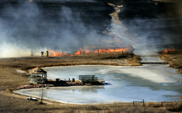 Firefighters in Berthoud battle a grass fire near HWY287 and HWY 52. Approximately 100 acres burned before ground crews brought the fire under control Monday January 19, 2009. Record high temperatures and high winds are making for high fire danger alon...