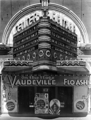 View of the Center Theater entrance and marquee at 1621 Curtis Street in Denver, Colorado; shows neon sign and lettering: "Vaudeville Sensational Nude Dancer Flo Ash," "Louise Fazenda - Maude Eburne Doughnuts and Society."