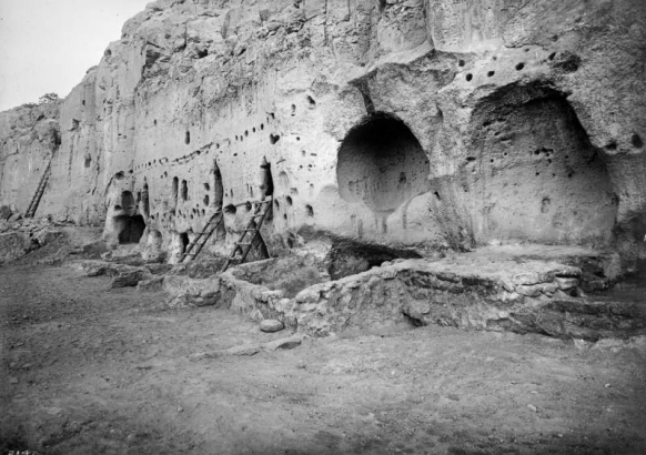 View of Long House Ruin, Native American (Anasazi) talus cliff dwelling, at Bandelier National Monument, New Mexico. Ladders lean against the tuff dwellings which have holes for vigas.