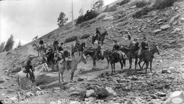 View of Pikes Peak trail at timberline with a group of men and women on horseback, El Paso County, Colorado.