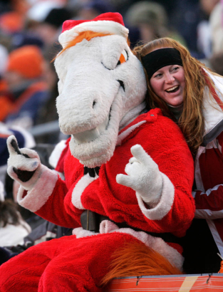 (1613) A fan gets her picture taken with Miles in the third quarter of the Denver Broncos against the Buffalo Bills at Invesco Field at Mile High in Denver., Colo., on Sunday, Dec. 21, 2008. Th Broncos lost 30-23. (CHRIS SCHNEIDER/ROCKY MOUNTAIN NEWS) **