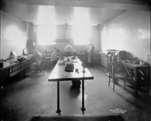 Assayers work in a laboratory at the Radium Company of Colorado mine in Colorado.