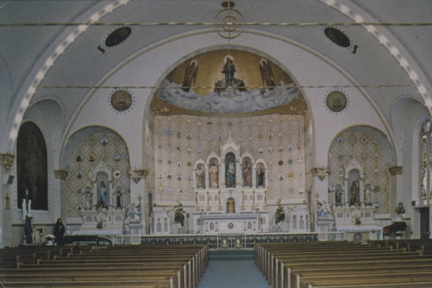 Interior view of Our Lady of Mount Carmel Church (1904 : Frederick Paroth), 3549 Navajo Street in the Highland neighborhood, Denver, Colorado. Shows the ornate Romanesque interior, the altar, pews, ceiling, wall murals and tile work, and painted statues.