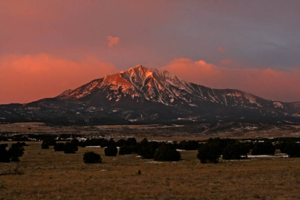 (Easement 2) Sunrise turns the sky and the Spanish Peaks pink Wednesday morning, January 30, 2008, Huerfano County, Colorado. The land in front of the peaks is part of the conservation easement  formed by ranchers in this area. (KEN PAPALEO/ROCKY MOUNT...