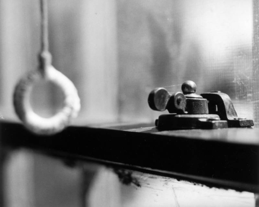 View of a window latch at 1325 Poplar Street in Denver, Colorado.