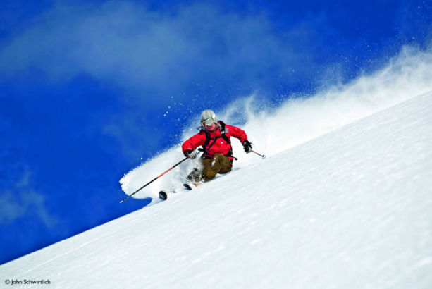 Ingrid Backstrom explores the pillars of ice and deep blue canyons of snow in the area around Blue River, British Columbia, Canada. From the film Higher Ground, by Warren Miller. 2005. Photo by Warren Miller Entertainment.