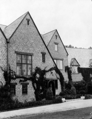 View of the George W. Gano house on South University Boulevard in Englewood, (Arapahoe County), Colorado. The two-story brick house has a hip roof, contrasting trim, and stained glass windows.