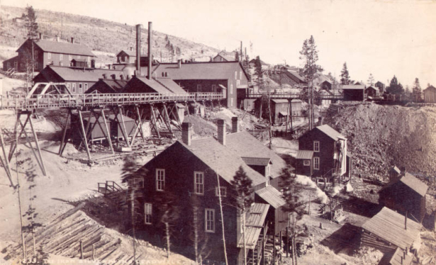 View of the Iron Silver Mine in Leadville, Lake County, Colorado. Shows Mine buildings, smokestacks and a trestle for ore cars.