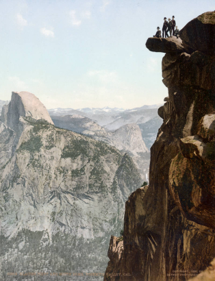 View of Glacier Point and Half (South) Dome and Yosemite Valley with group of men atop rock precipice, Yosemite National Park, California.