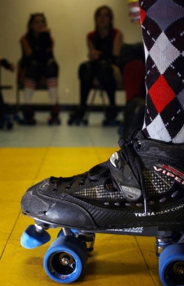 Bruisin' Bardot(cq), front leg and skate, and the rest of the Red Ridin' Hoods roller derby team prepare to take on the Sugar Kill Gang during a team meeting before the second match of the Rocky Mountain Roller Girls at the Bladium Sports Club in Denve...