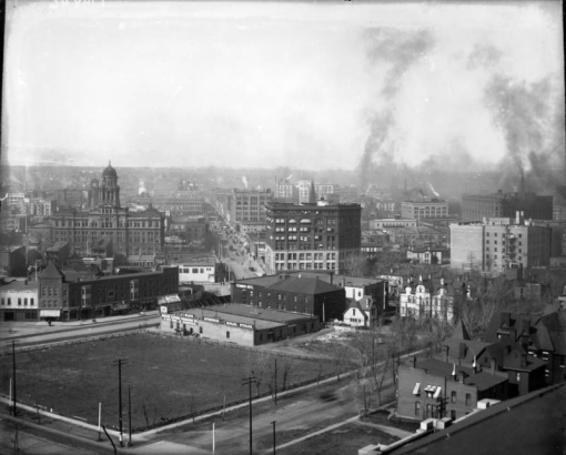 Rooftop view of downtown Denver, Colorado. Buildings include the Arapahoe County Courthouse, Orpheum Theater, Daniels and Fisher Tower, Kittredge Building, and the Majestic Building. Signs read: "A. T. Wilson," "Automobiles Repairs Storage," and "Plymouth Hotel."