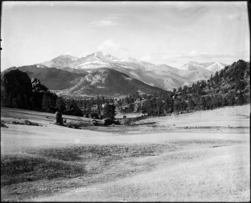View across undeveloped meadow, Estes Park, Colorado towards Longs Peak (elevation 14,255 feet) and Mount Meeker (elevation 13,911 feet); Rocky Mountain National Park, Rocky Mountains.