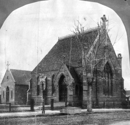 Exterior of the Evans Chapel, Denver, Colorado; a small grand, Gothic, stone structure features: a steep front gable with a stone cross, side entry vestibule, stained glass windows, and roof cresting; built in 1873-1878 by Dr. John Evans, (Colorado's second territorial governer) in memory of his daughter, Josephine Elbert; later moved to the Denver University campus for preservation.