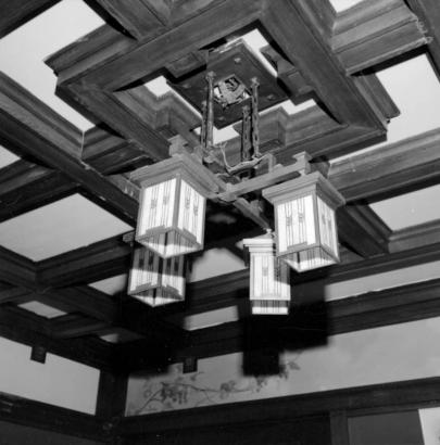 Interior view of a lighting fixture in the Frederick Warshauer residence in Antonito, Conejos County, Colorado; features a bronze fixture with four lamps covered with square stained glass lanterns hung by chains from a decorative beamed ceiling; Warshauer, born in Posen, Germany, was a prominant banker and rancher in Antonito.