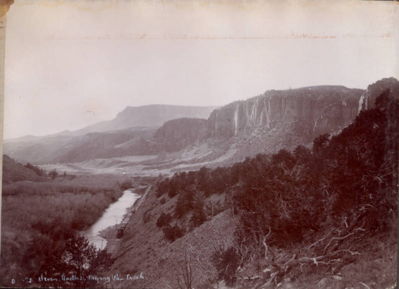 View of Seven Castles rock formation near Basalt (Eagle County), Colorado. A Colorado Midland Railway locomotive and train parallels the Fryingpan River.