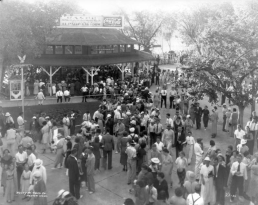People stroll at Lakeside Amusement Park in Lakeside (Jefferson County), Colorado; a sign atop a pavilion reads: "El Patio Ballroom" and "Coca Cola."