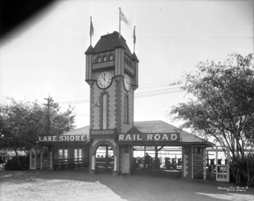 View of the Lake Shore Railroad depot at Lakeside Amusement Park in Lakeside (Jefferson County), Colorado; a clock tower tops the arched entry.