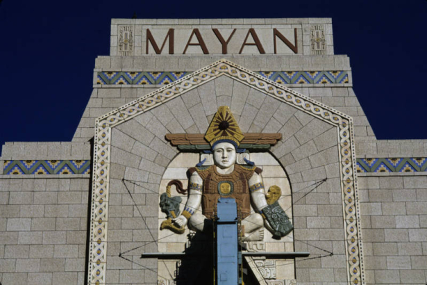 Detailed view of the top of the facade of the Mayan Theater (architect Montana S. Fallis, 1930) at 110 Broadway in the Speer neighborhood of Denver, Colorado. Shows a polychrome terracotta Mayan figure (crafted by Julius P. Ambrusch of the Denver Terra Cotta Company) on the front of the Art Deco-style theater. The facade was restored by architects Midyette-Seieroe, in 1985.