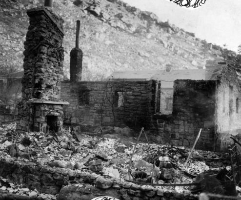 Only the stone chimney and fireplace remain at one of the cottages that burned during the fire of December 28, 1929, at the resort in  Eldorado Springs, Colorado.