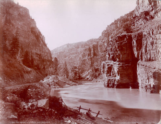 View of Glenwood Canyon and the Colorado River with the "Glenwood Extension" of the Denver & Rio Grande Railroad line in Garfield County, Colorado. Shows telegraph poles.