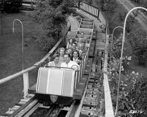 Men and women ride a roller coaster at Elitch Gardens in Denver, Colorado.