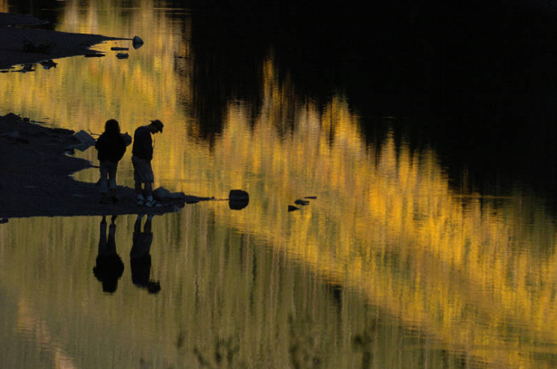 Visitors enjoy the sunset  and the reflection of the aspens in Maroon Lake Monday afternoon September 26, 2005, at the Maroon Bells in Aspen. The Maroon Bells are one of the most photographed places in Colorado during the show of color by the aspen tre...